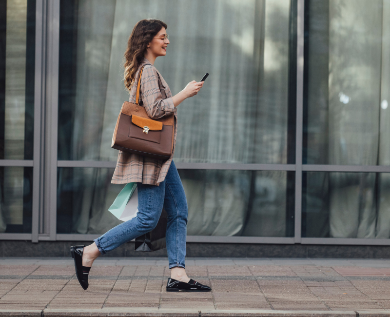 Woman walking and texting
